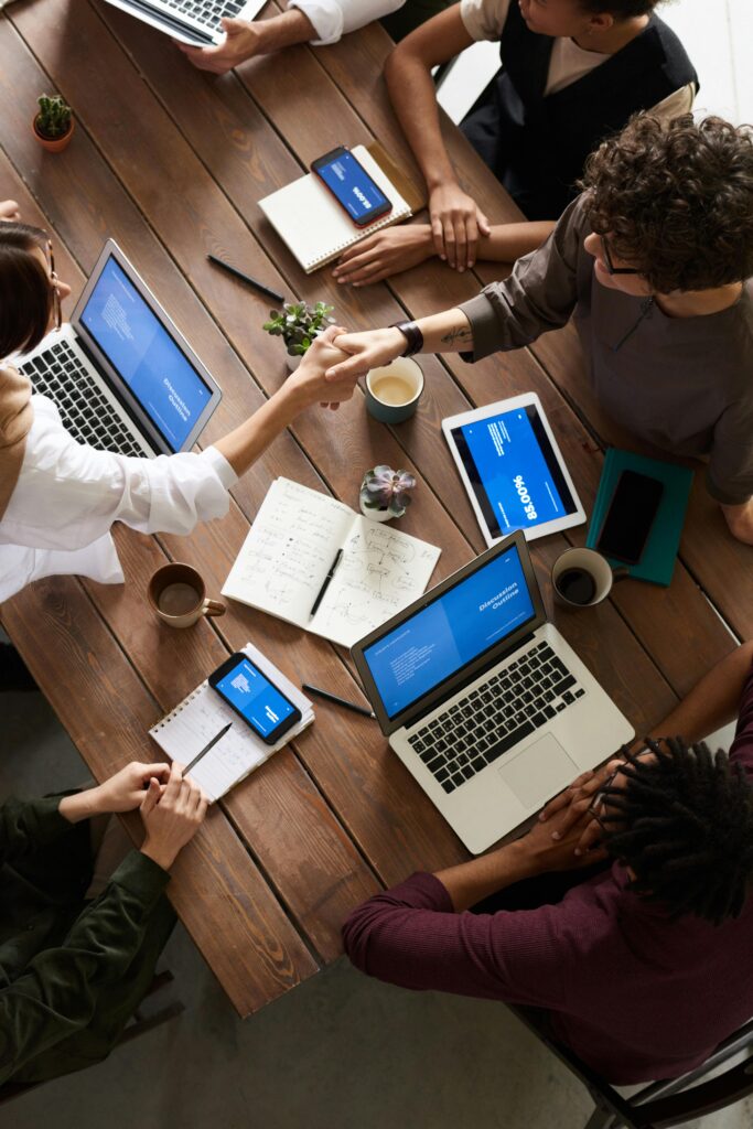 pexels-photo-3183148-3183148 A diverse group of professionals brainstorming in a modern workspace with laptops and notebooks.